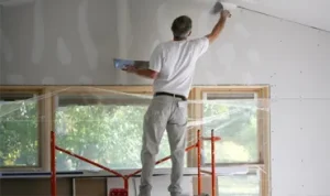 Plastering a wall in West London house