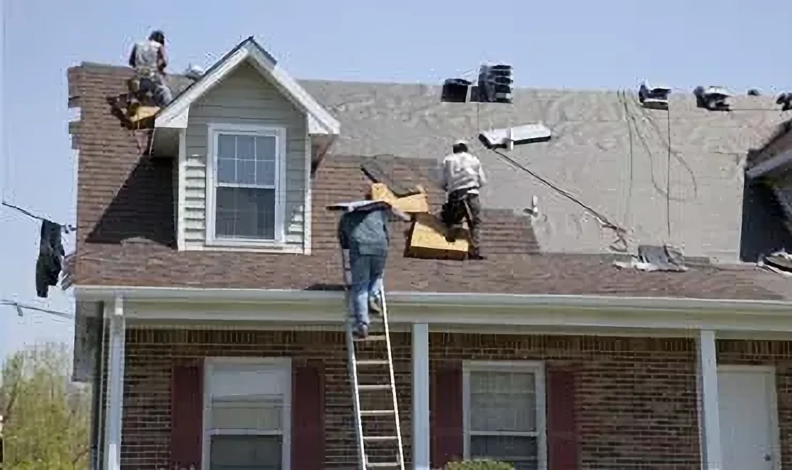 Installing roofing tiles on London house
